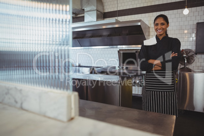 Portrait of happy waitress in cafe