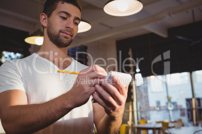 Young waiter taking order