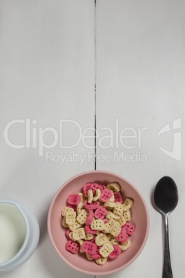 Bowl of honeycomb cereal and milk on wooden table