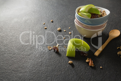 Bowls of breakfast cereals with fruits on black background
