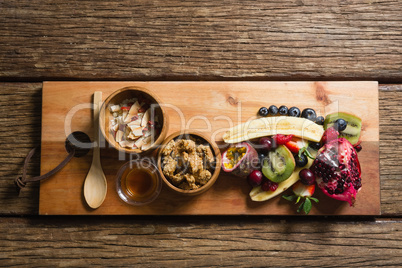 Breakfast and fruits on chopping board