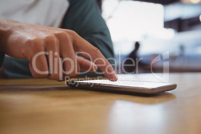 Cropped image of man touching mobile phone