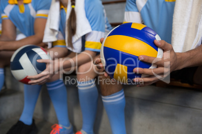 Mid section of man holding volleyball
