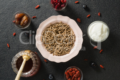 Bowl of cereal bran stick, yogurt, honey and dried fruits