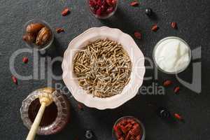 Bowl of cereal bran stick, yogurt, honey and dried fruits