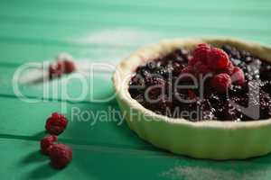 Blackberries and raspberries on tart in baking pan