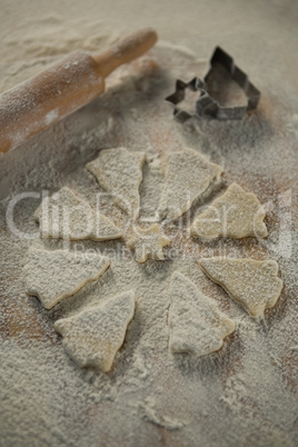 High angle view of Christmas tree and star shape cookie dough