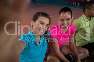 Portrait of smiling volleyball players relaxing