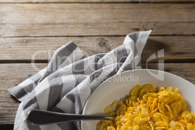 Bowl of wheaties cereal and spoon with napkin