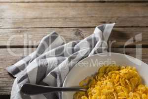 Bowl of wheaties cereal and spoon with napkin