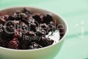 Close up of raspberry with syrup in bowl
