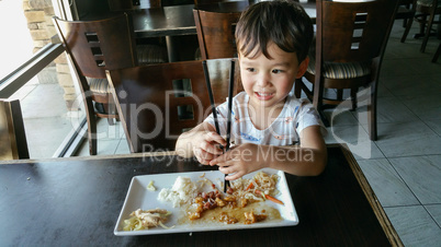 Cute Young Chinese and Caucasian Boy Learning To Use Chopsticks