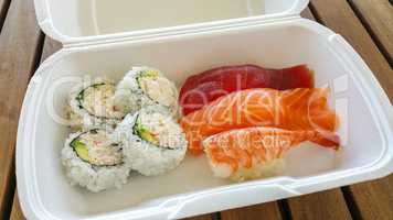 Delicious Sushi Variety in To Go Box on Table