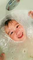 Happy Cute Young Chinese and Caucasian Boy Having Fun at Bath Ti