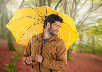 Man in Autumn with umbrella in forest