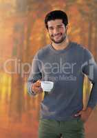 Man in Autumn with cup in forest