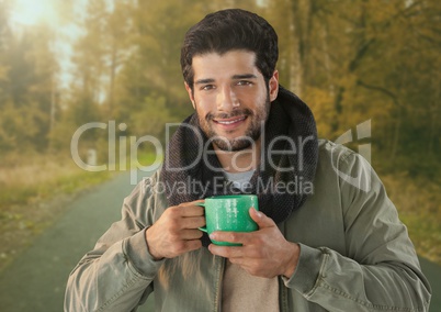 Man in Autumn with cup in forest