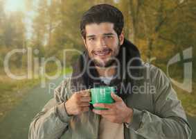 Man in Autumn with cup in forest