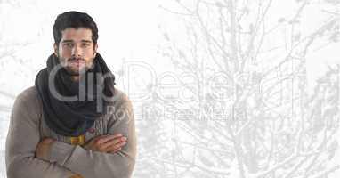 Man wearing scarf with arms folded in  bright snow forest