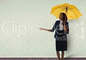 Businesswoman holding umbrella in room