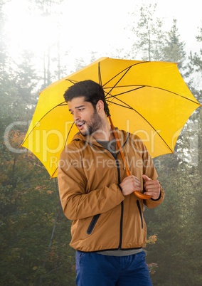 Man in Autumn with umbrella in forest