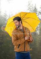 Man in Autumn with umbrella in forest