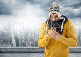 Man keeping warm in hat and scarf in city