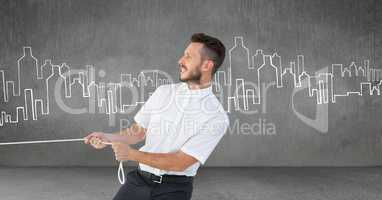 Businessman pulling rope in room with city drawings