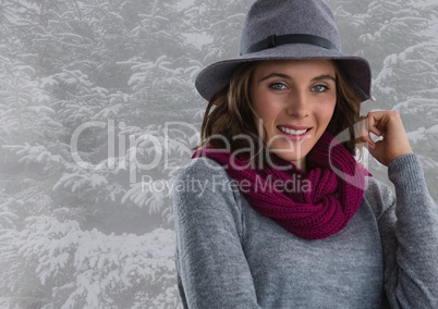 Woman in hat and scarf in snow forest