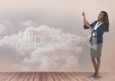 Businesswoman pointing up with clouds