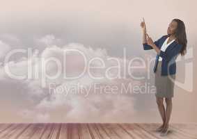Businesswoman pointing up with clouds