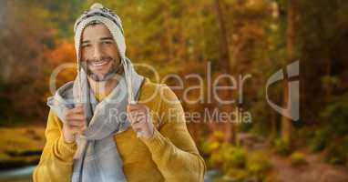 Man in Autumn with scarf and hat in forest