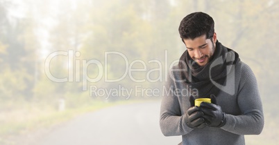 Man in Autumn with cup in bright forest