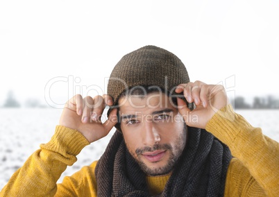 Man wearing hat and scarf in snow landscape