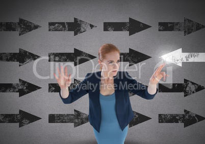 Businesswoman touching glowing arrow in opposite direction