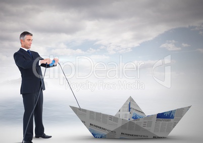 Businessman pulling paper boat