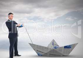 Businessman pulling paper boat