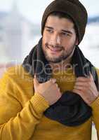 Man wearing scarf and hat with blurred background