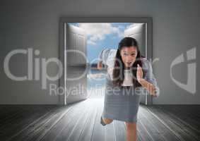 Businesswoman running in door from outside