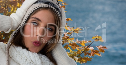 Woman in Autumn with hat and hood with tree leaves