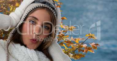 Woman in Autumn with hat and hood with tree leaves