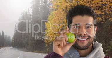 Man in Autumn with apple in forest