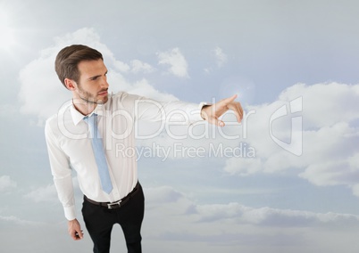 Businessman pointing in clouds