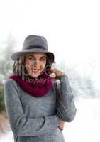 Woman wearing hat and scarf in snow forest