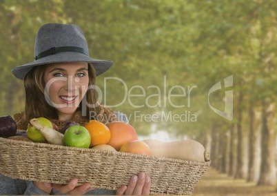 Woman in Autumn with basket of fruit in forest