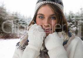 WOman wearing gloves and hat in snow forest