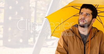 Man in Autumn with umbrella in bright wood park