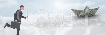 Businessman with briefcase and money dollar paper boat in clouds