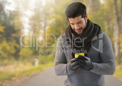 Man in Autumn with cup in forest