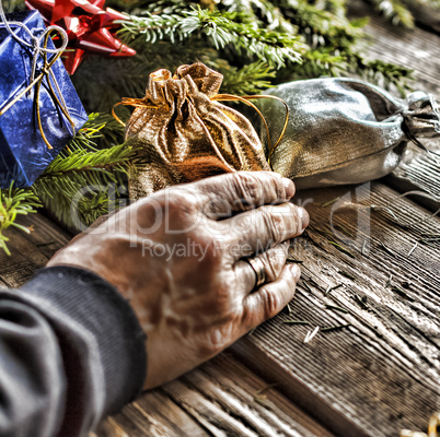 Man puts presents under the Christmas tree.